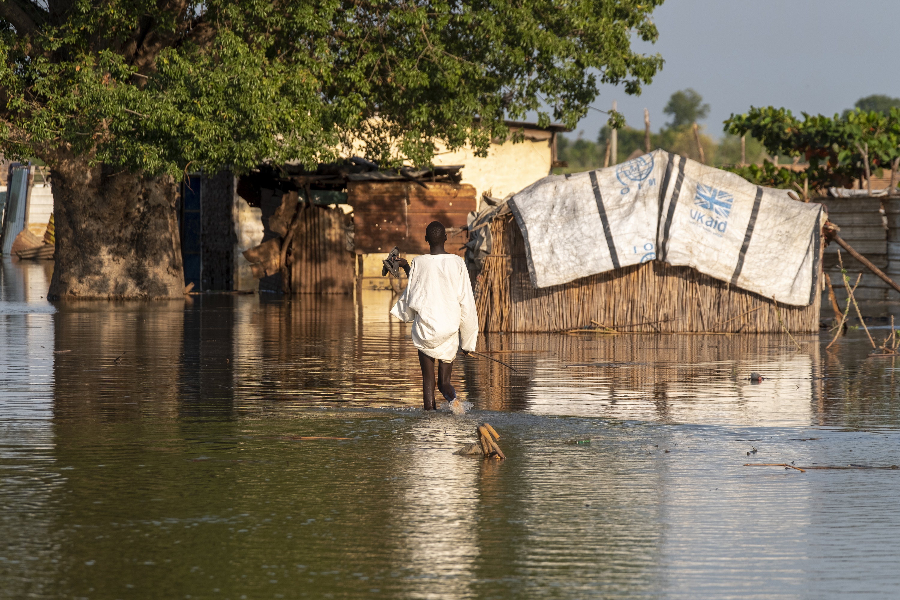 Child walking in flooded area.