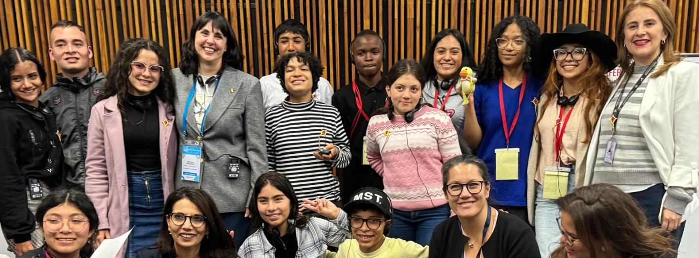Dr. Najat Maala M'jid sitting with children during the Bogota conference.