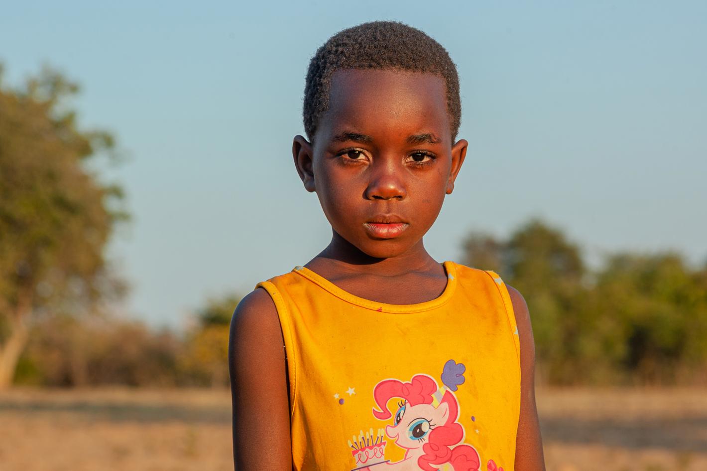 A girl stands in a farm field on 19 June 2024 in Maambo village, Southern province, Zambia.