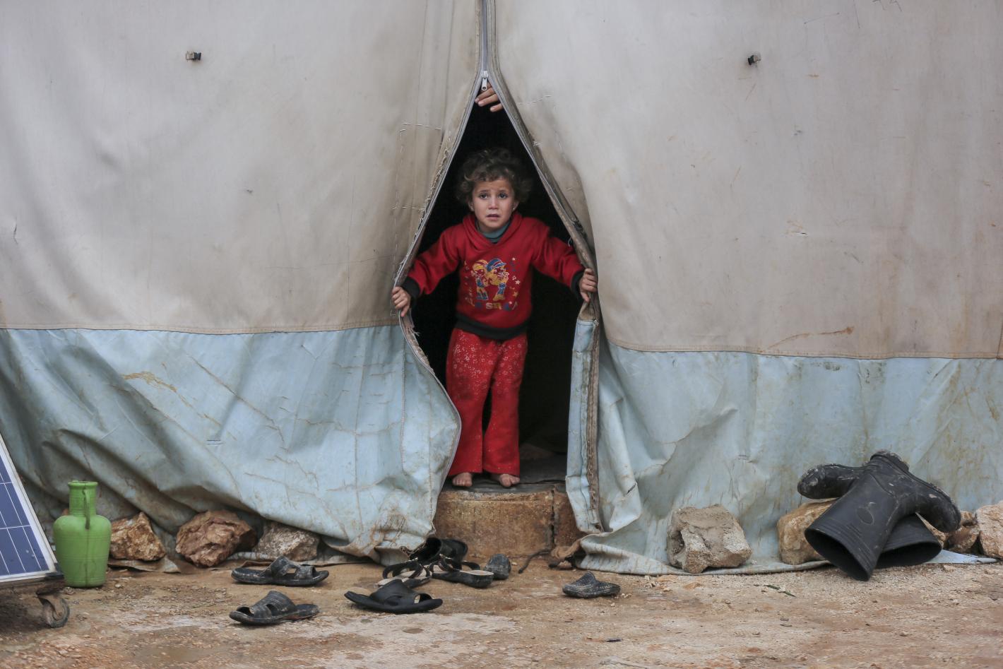 Child looking out of a detention camp