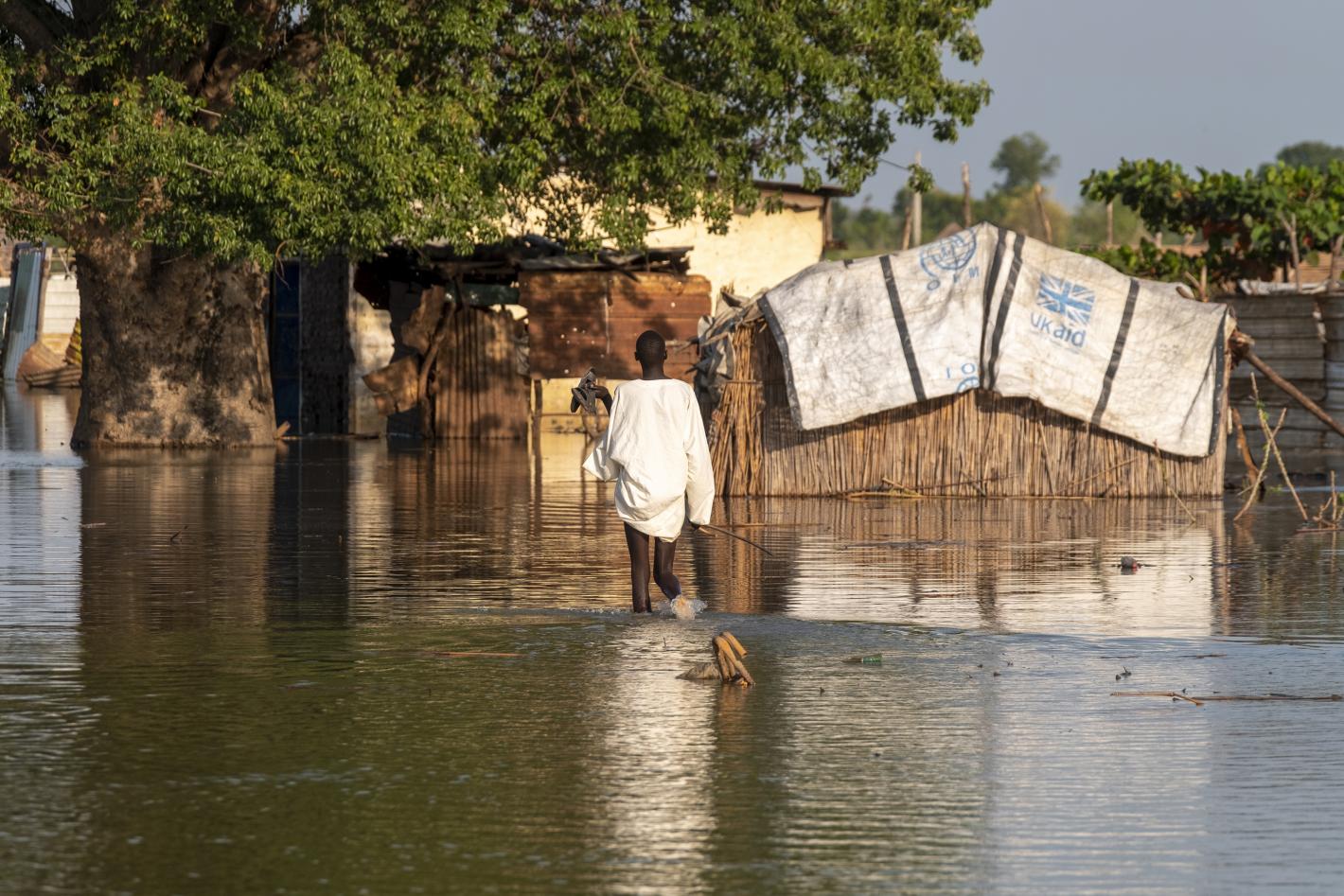 Child walking in flooded area.